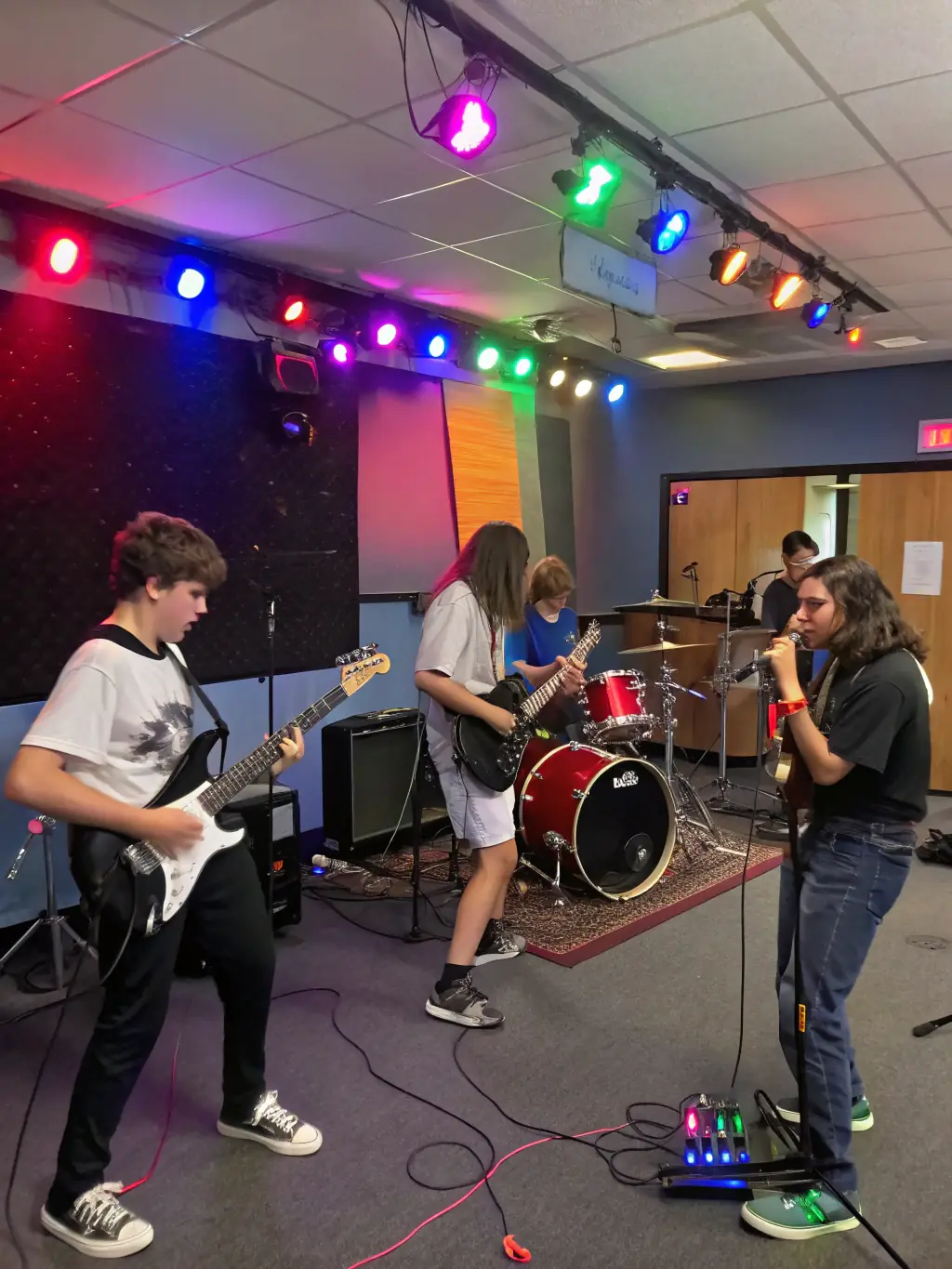 A dynamic image of a band rehearsing in a studio, capturing the energy and collaboration involved in preparing for a performance.